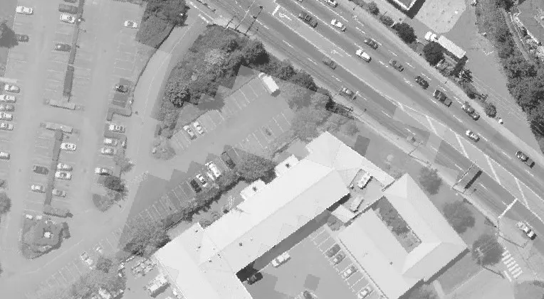 Aerial view of Island Highway showing traffic and a parking lot