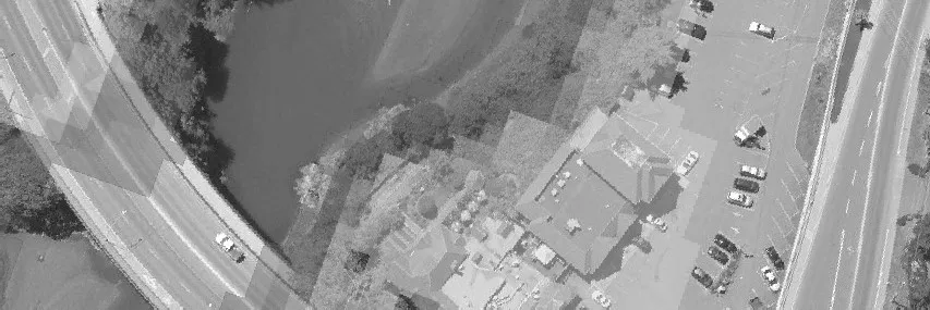 Aerial view of a commercial building and its parking lot