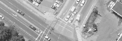 Aerial view of a busy roadway intersection with many cars