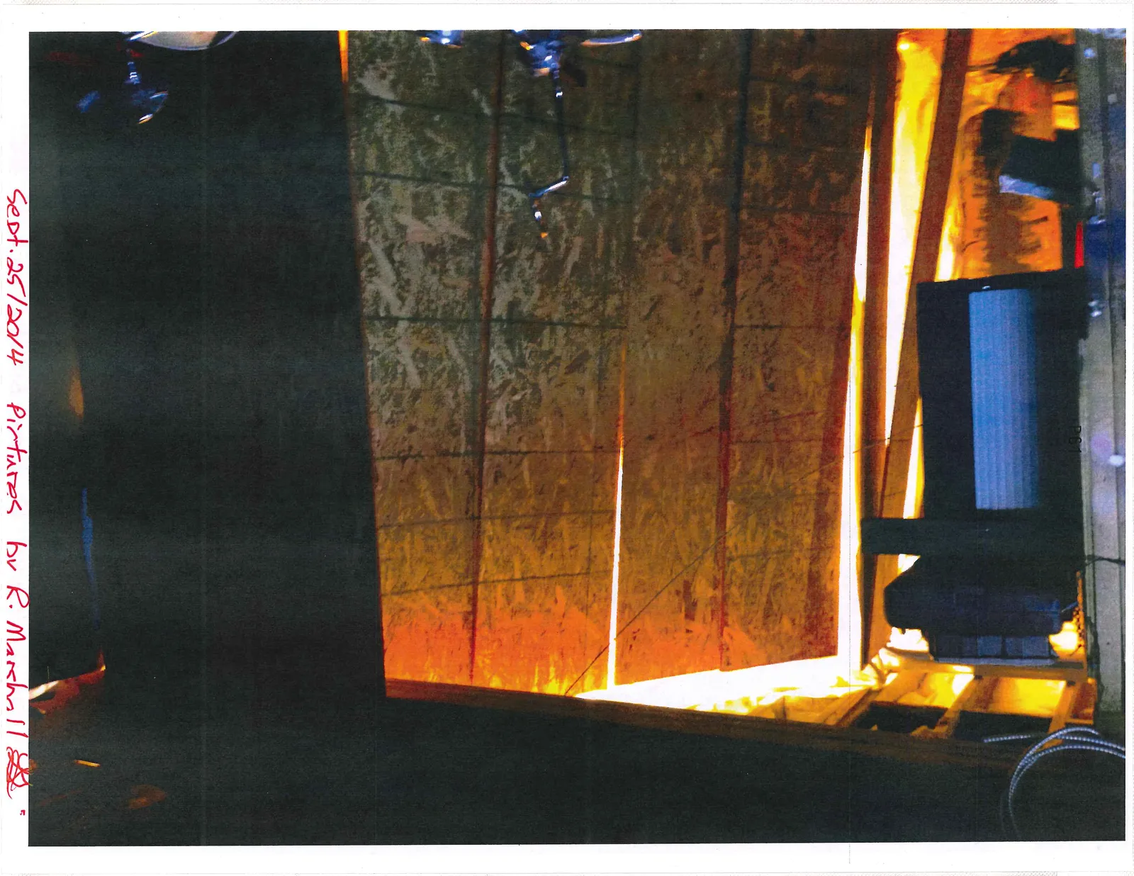 Interior structure with OSB panels and bright light shining through gaps between the wood framing.