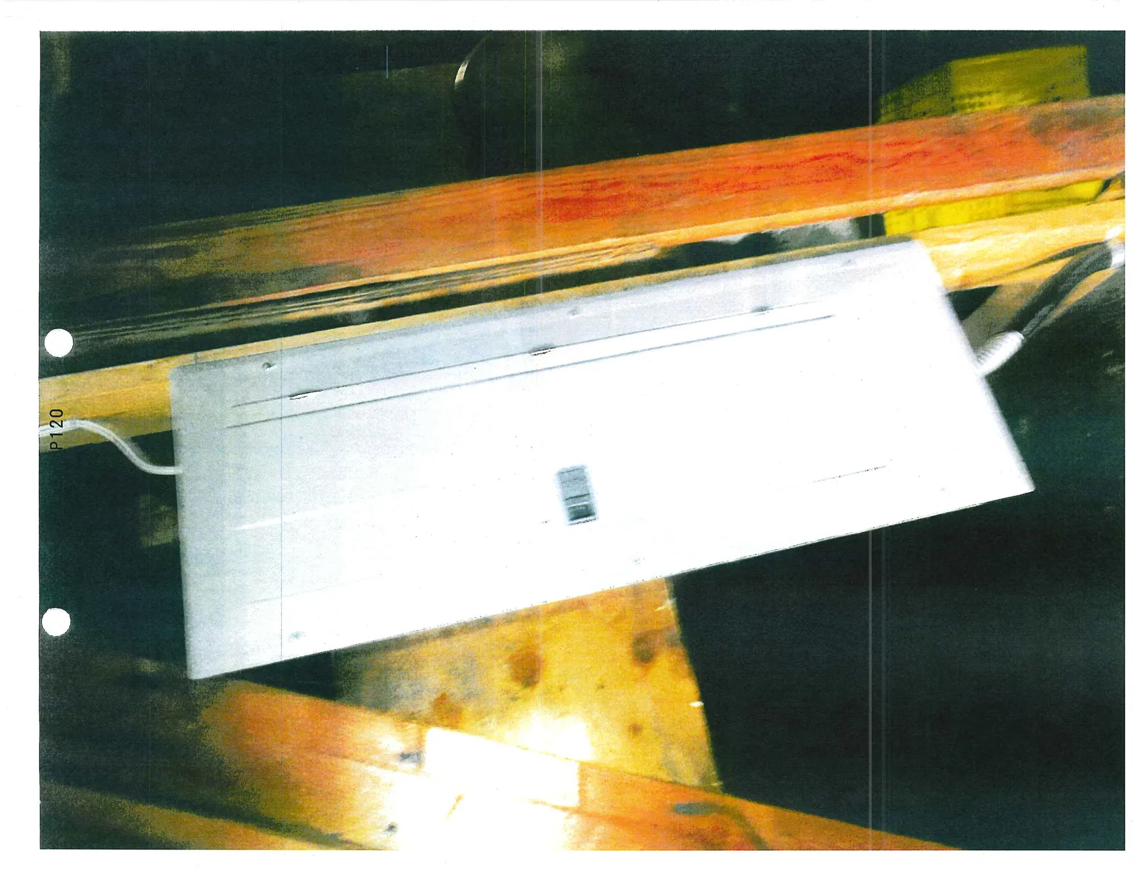 White electrical panel cover mounted vertically on wooden framing