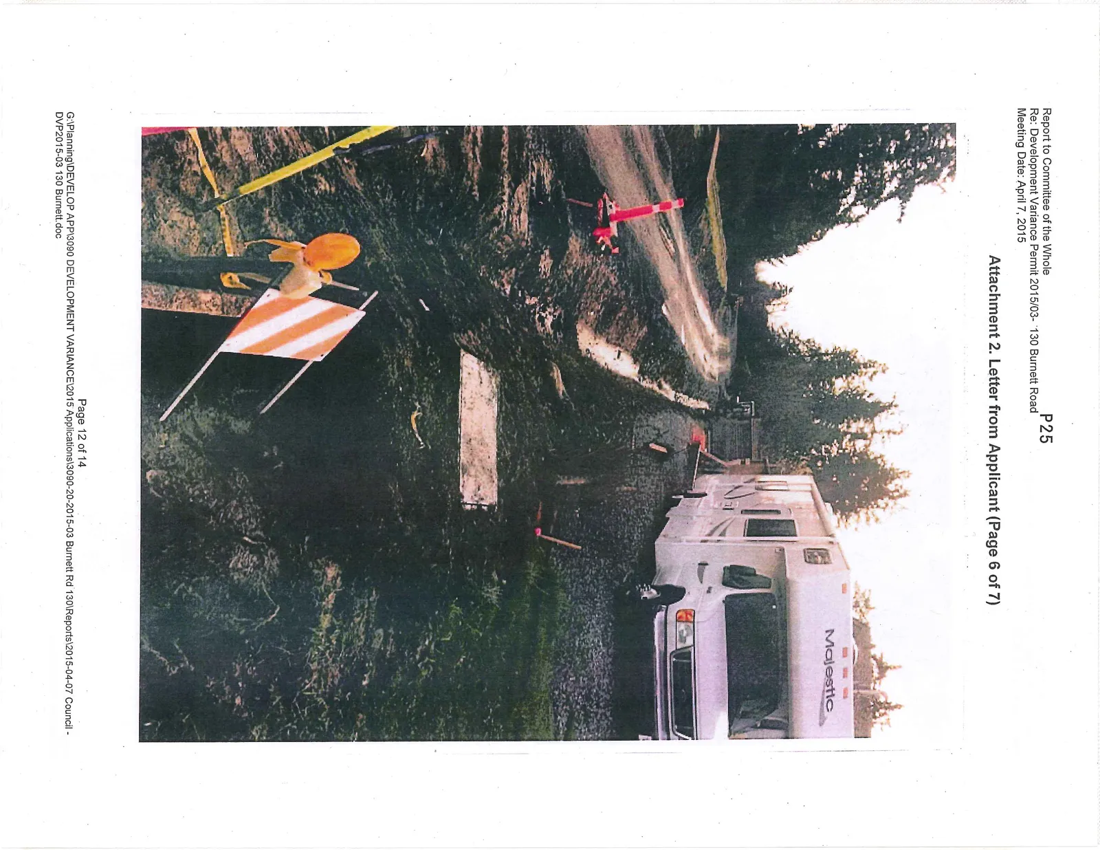 Photo showing a muddy drainage trench and safety markers at the construction site next to an RV