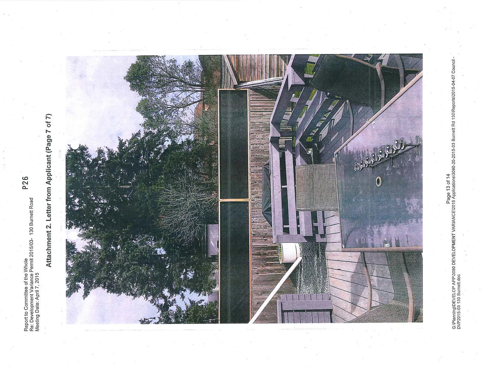 Photo from a backyard deck showing the existing fence with dark framed panels added to the top as a height mockup
