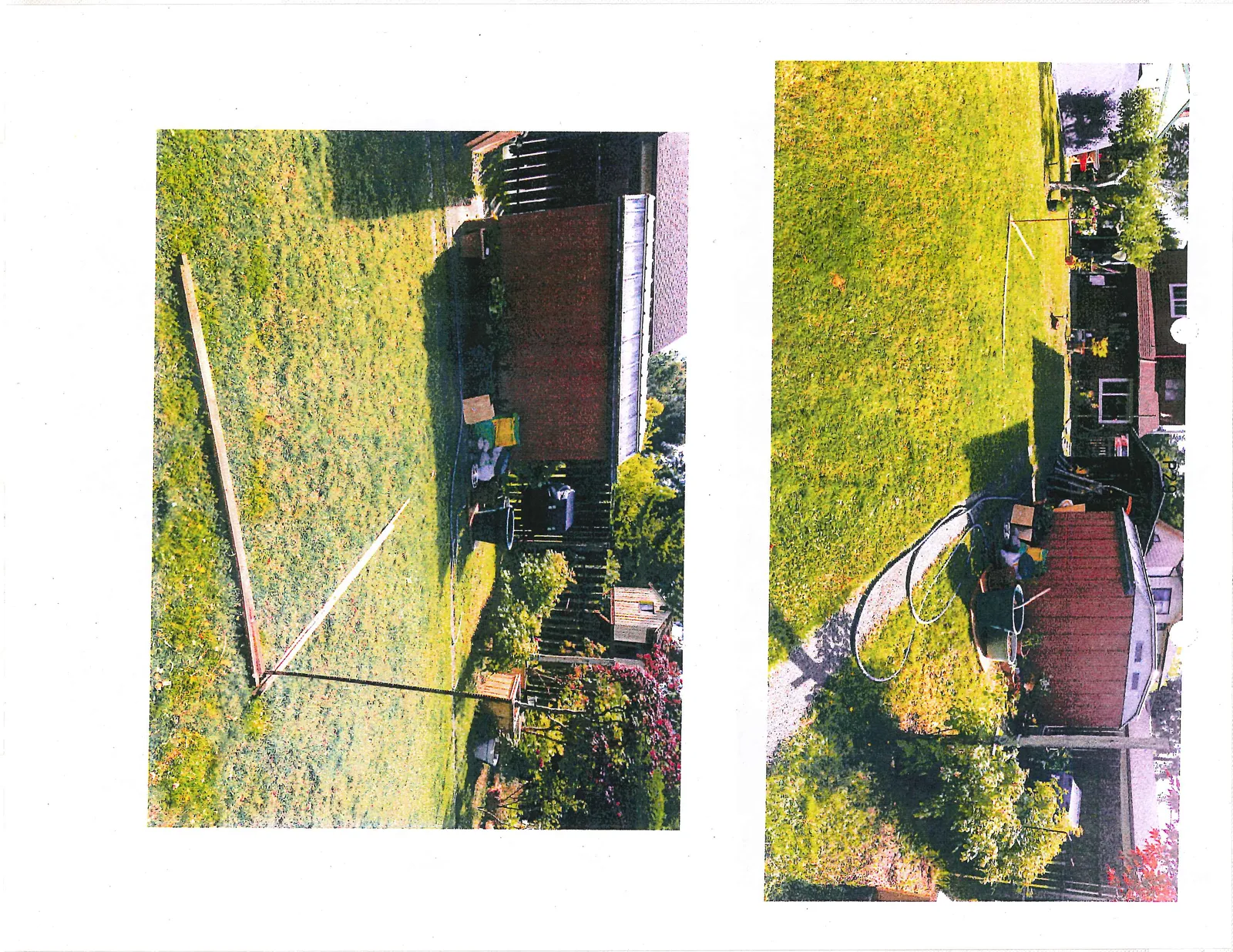 Photograph of a backyard area featuring a red garden shed, garden equipment, and a wooden L-shaped layout frame on the lawn, looking toward a house in the background.