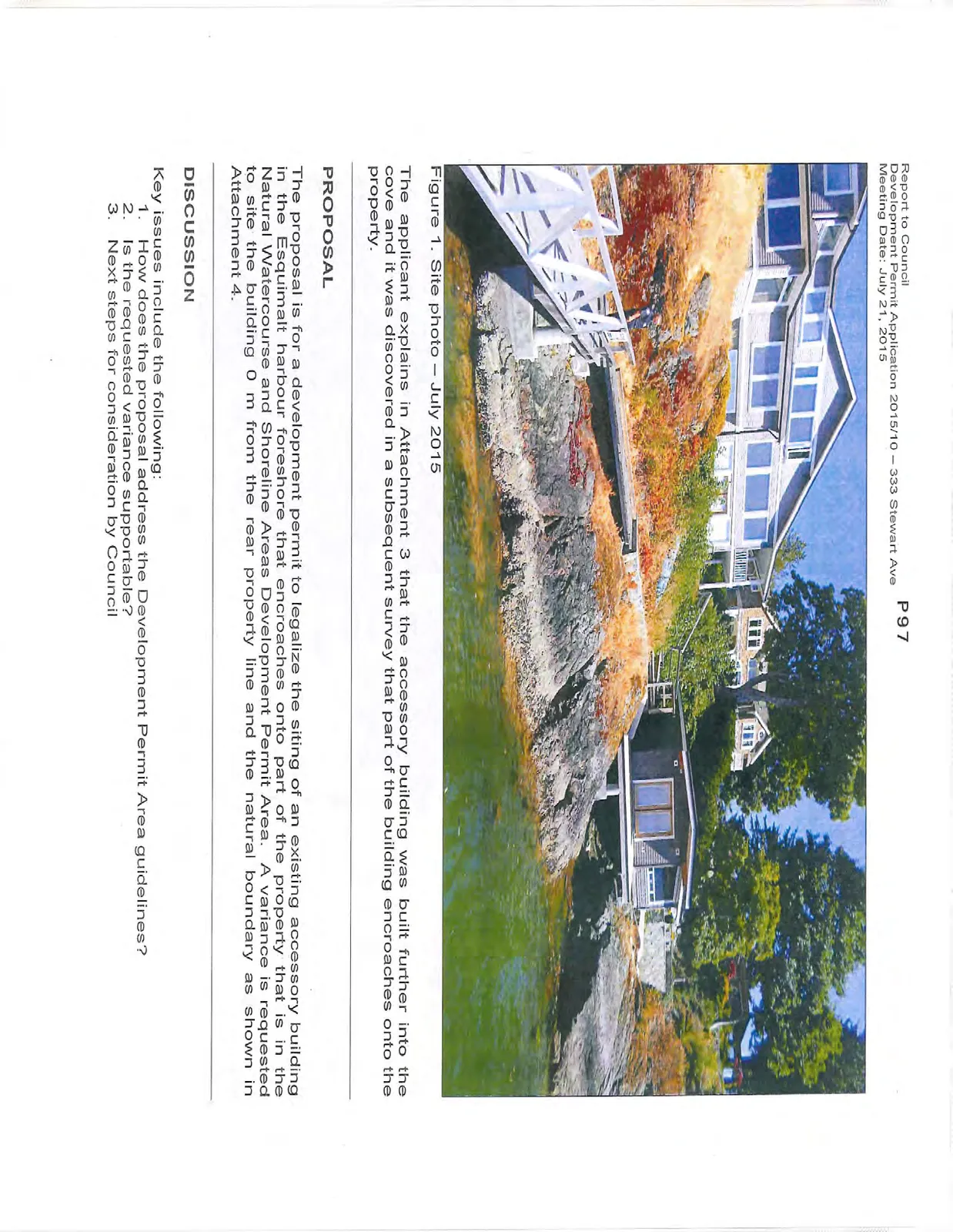 Site photo showing the house and a small accessory building on a rocky shoreline with a dock and walkway