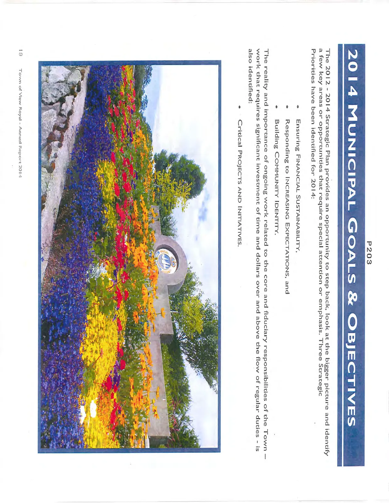 Photo of colorful flower gardens in front of a stone wall