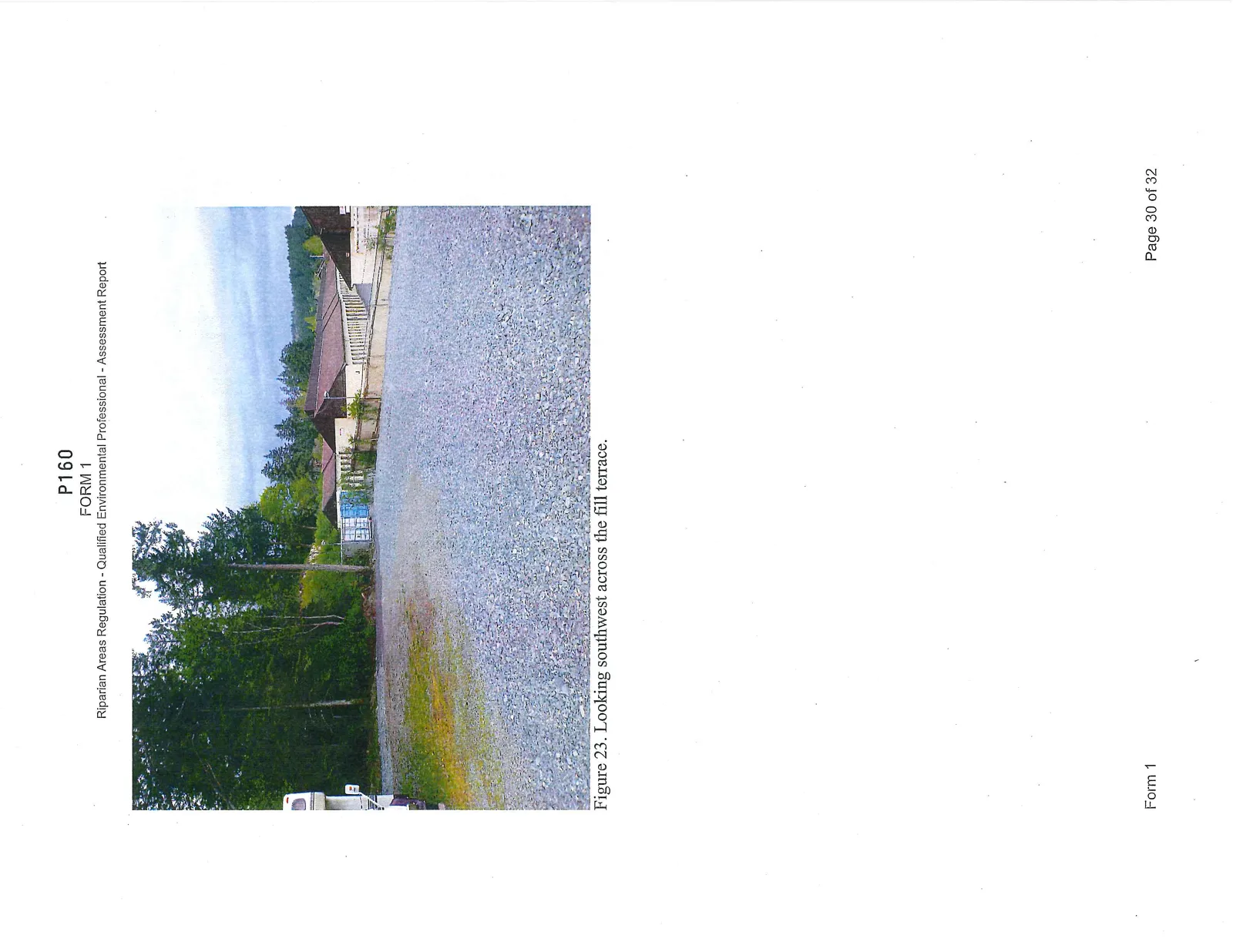 Photograph showing the fill slope from the old floodplain terrace, primarily composed of rock and covered with brush.