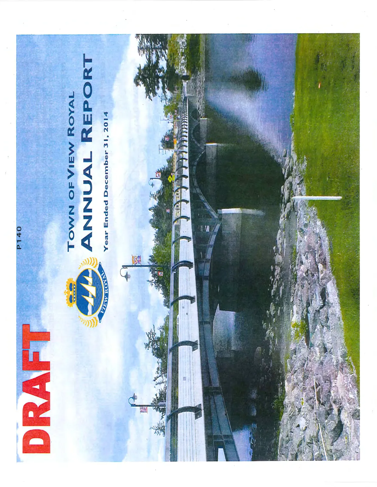 A photo of the Craigflower Bridge over water with rocks and grass in the foreground.