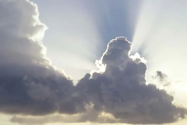 Sunlight breaking through dark, dramatic clouds