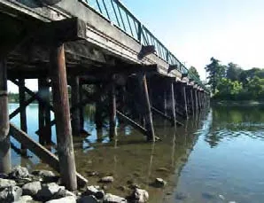 Low angle view of a wooden pier or bridge extending over water
