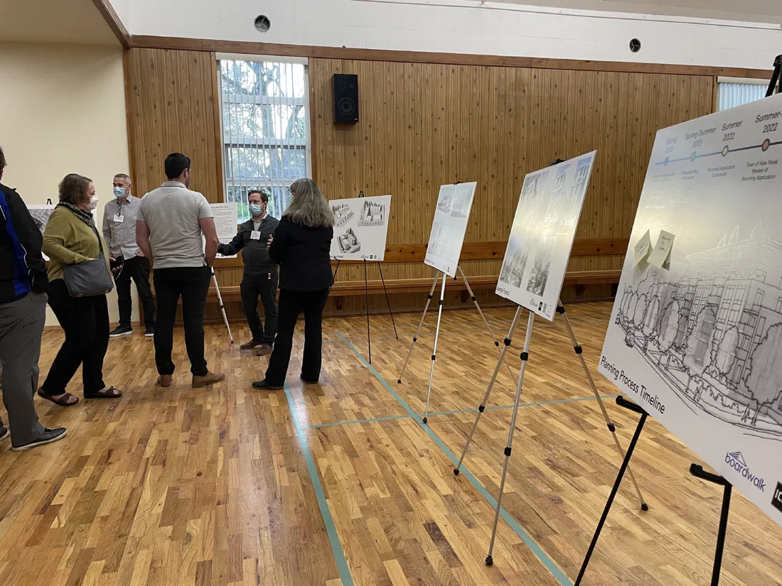 Photo of an attendee reviewing a site plan display at the June 2023 neighbourhood information session.