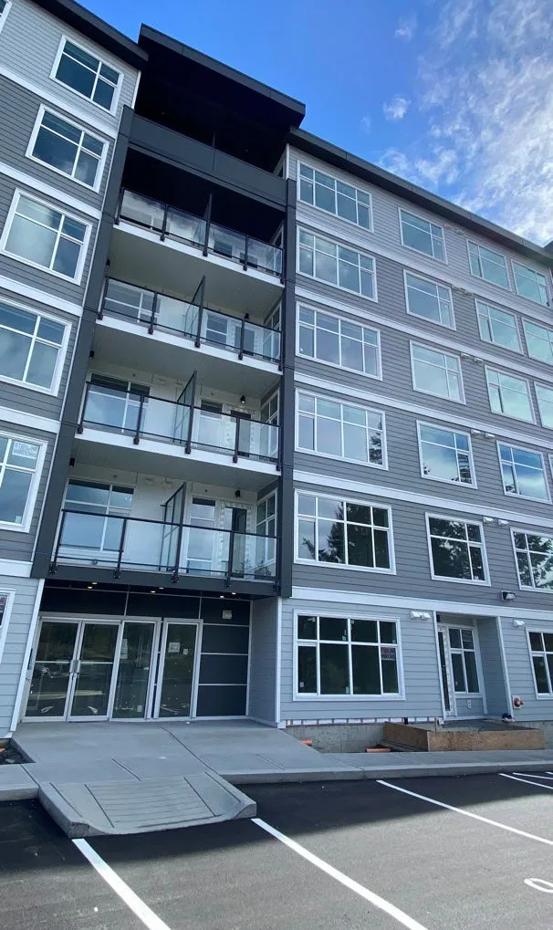 Modern multi-story apartment building with balconies and large windows