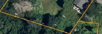 Close-up aerial view showing the existing residence and backyard area