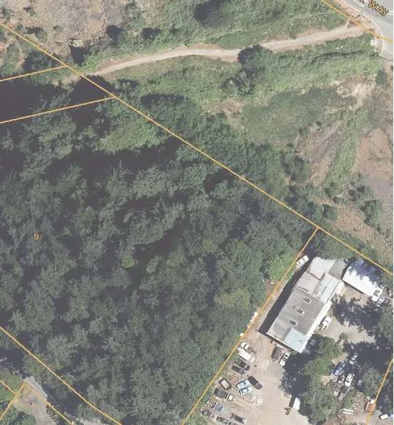 Close-up aerial view showing the existing residence and backyard area