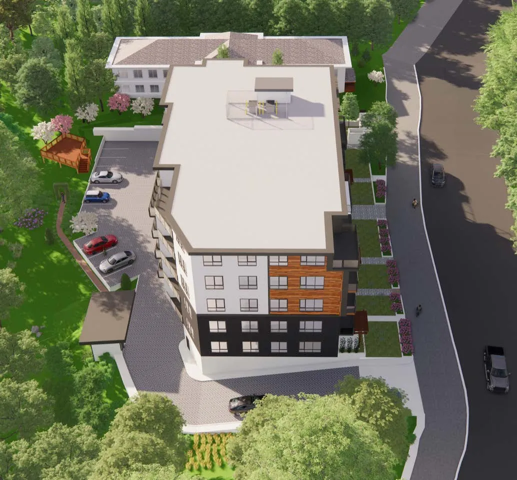 3D architectural rendering of a multi-story residential building featuring a mix of white, black, and wood-textured exterior panels, an adjacent surface parking lot with several cars, and landscaped green space with trees and a wooden deck.