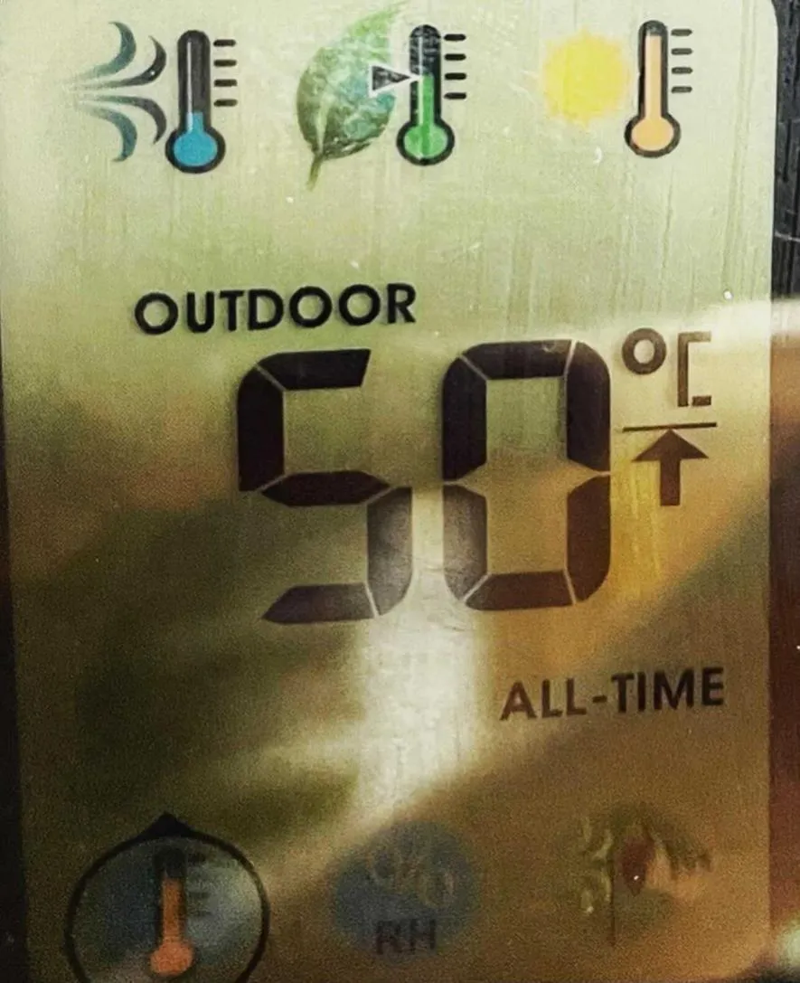 Outdoor thermometer display showing an "ALL-TIME" record temperature of 50°C