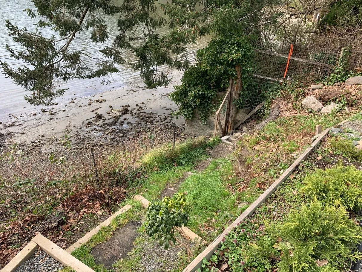 Photo 11. Existing shoreline access path and stairs, with wood (failing) and concrete block retaining walls.