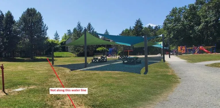 Design concept rendering of a playground and shade structure with a red line indicating "Not along this water line"
