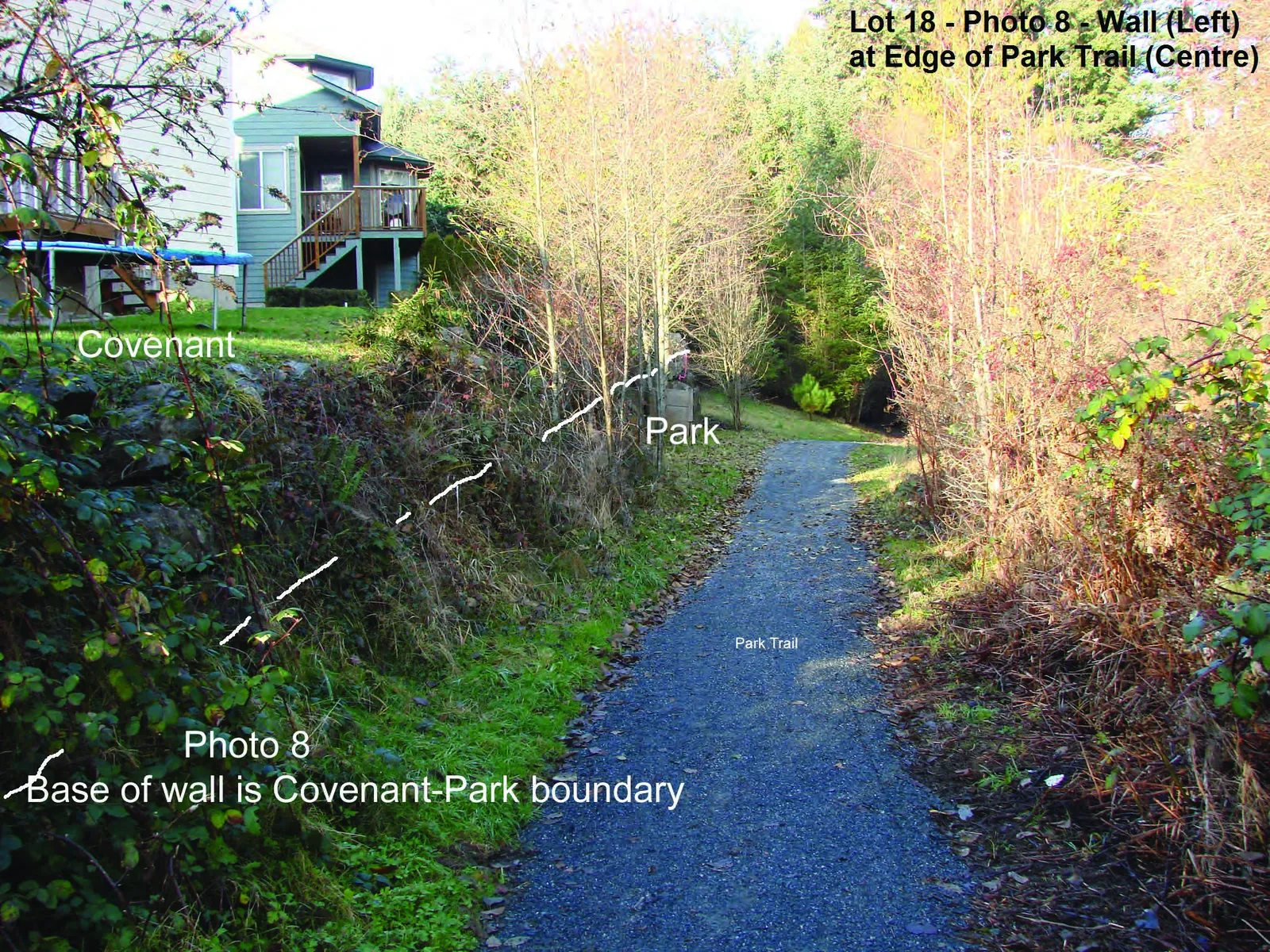 Photograph of a large wooden compost bin situated in the park area adjacent to the Lot 18 covenant wall