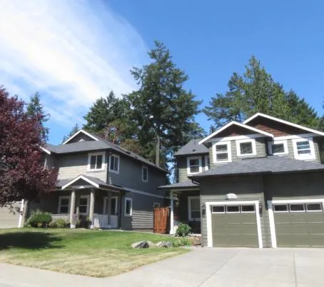 Front view of two modern suburban houses with a driveway