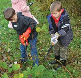 Two children gardening outdoors