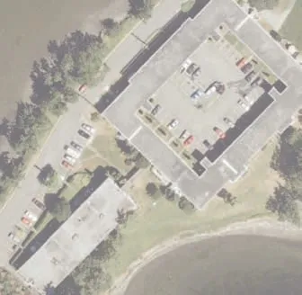 Aerial view of residential building and adjacent parking