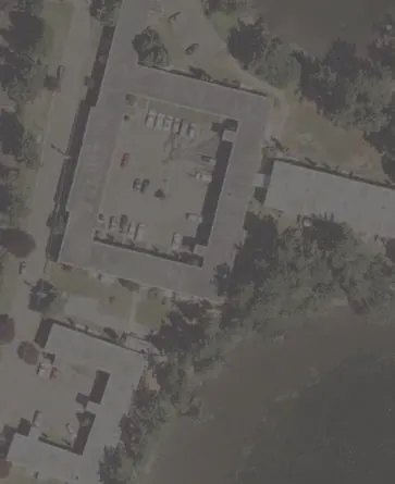 Aerial view of residential building and parking area