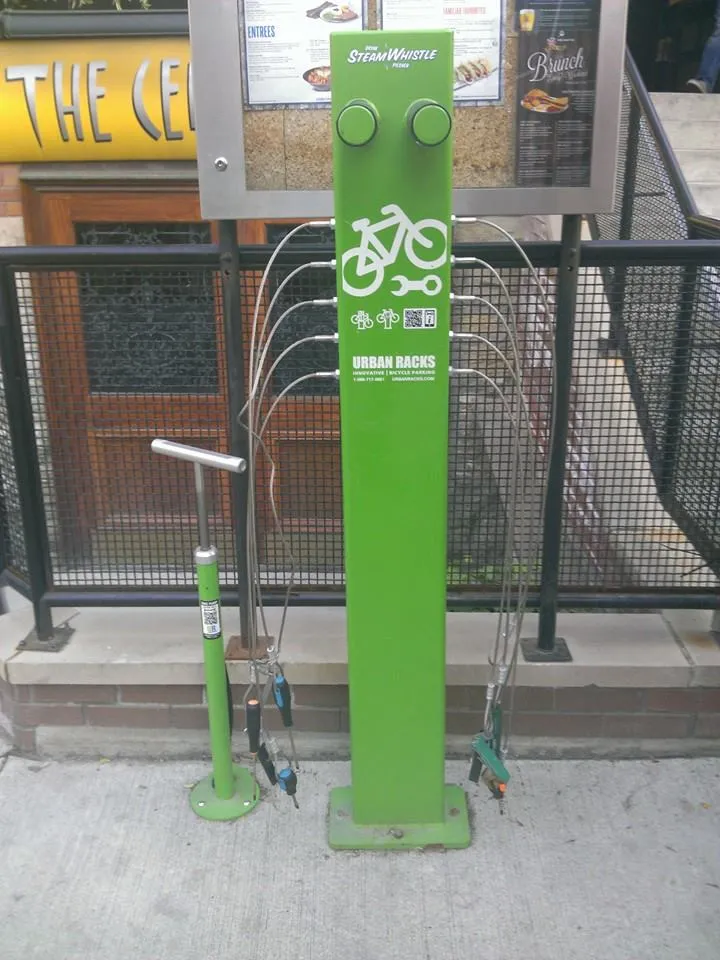 Bicycles on vertical pole-mounted racks in a parking garage