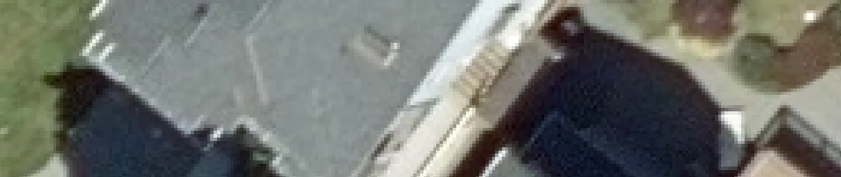 Aerial view crop of a house and backyard structure