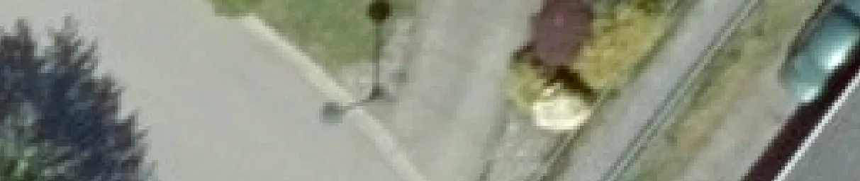 Aerial view crop of a driveway and neighboring property