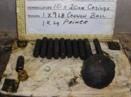 Recovered Hand Grenade shown with measuring tape for scale