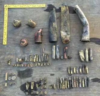 Collection of various rusted munitions recovered from the harbour floor