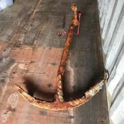 Large clamshell dredging bucket emerging from the water