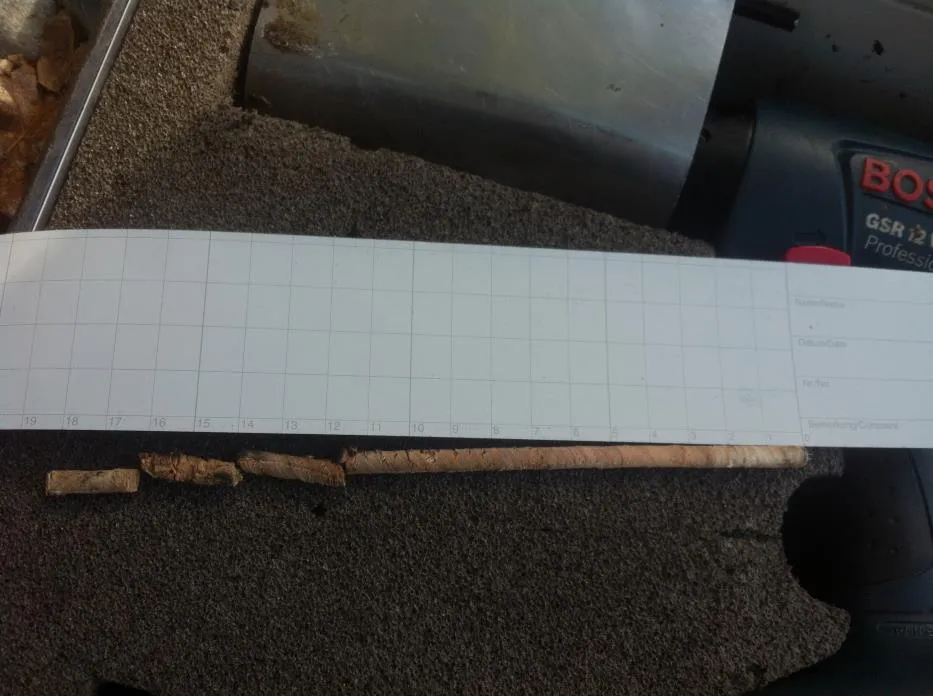 Increment sample core showing signs of decay placed on a scale