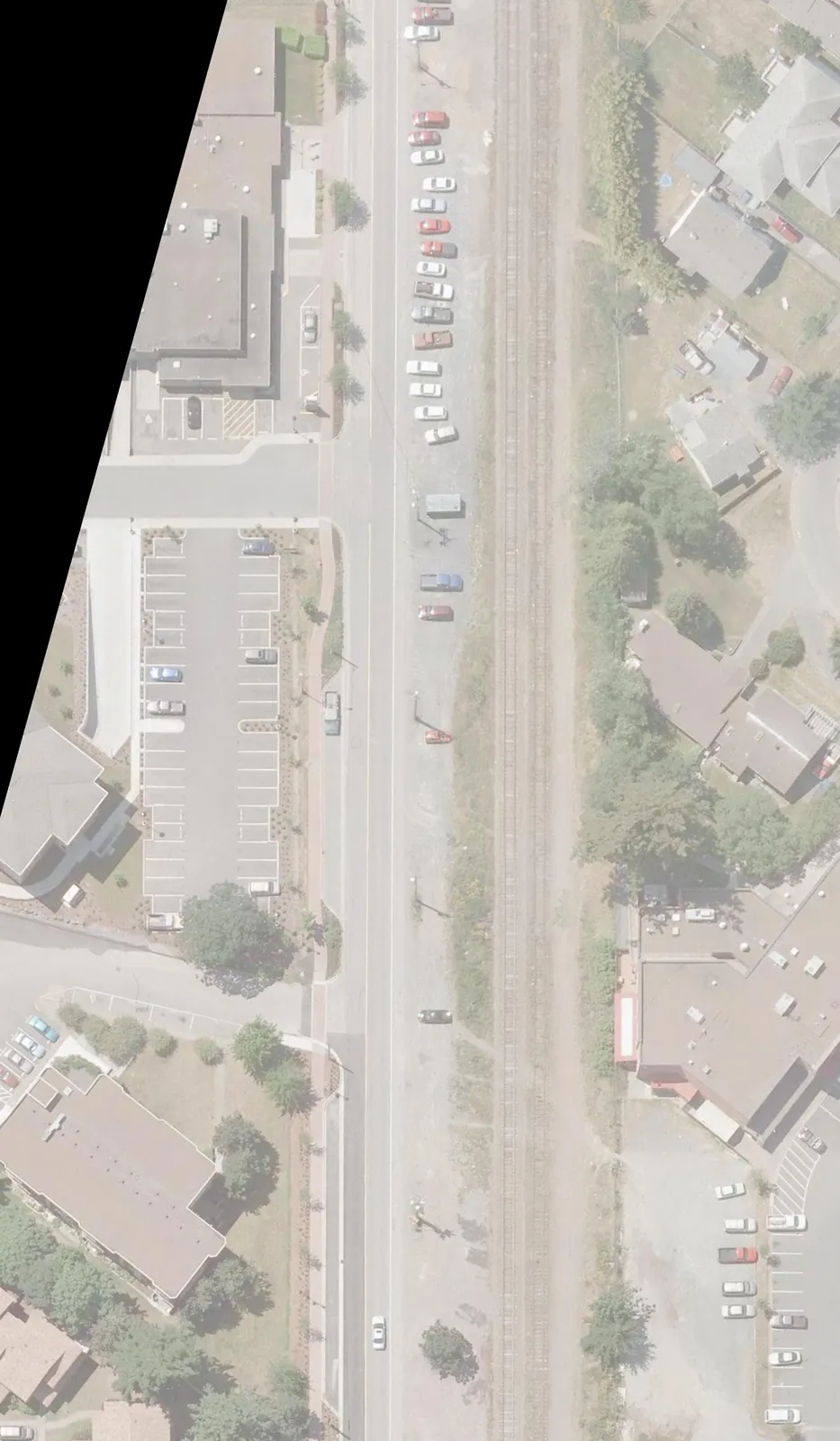 Aerial view showing parking stall configurations along Station Avenue and the E&N Railway