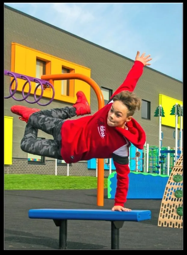 Photo of a child playing on a Blue Imp playground structure