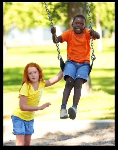 Photo of children using playground swings