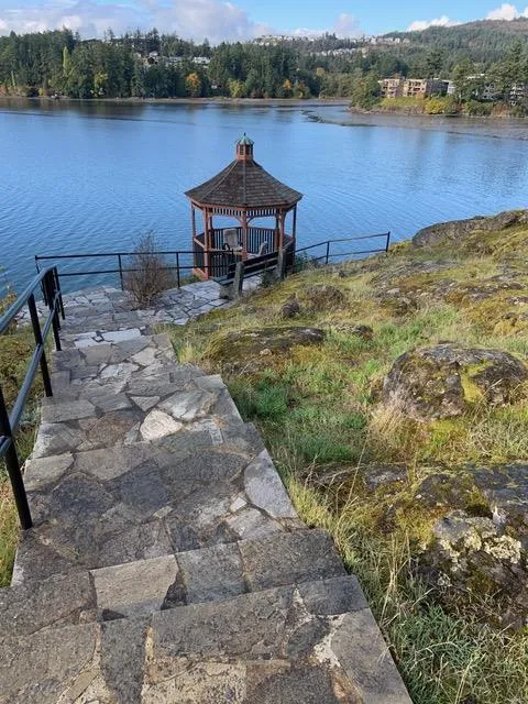 Stone steps leading down to a gazebo on the water