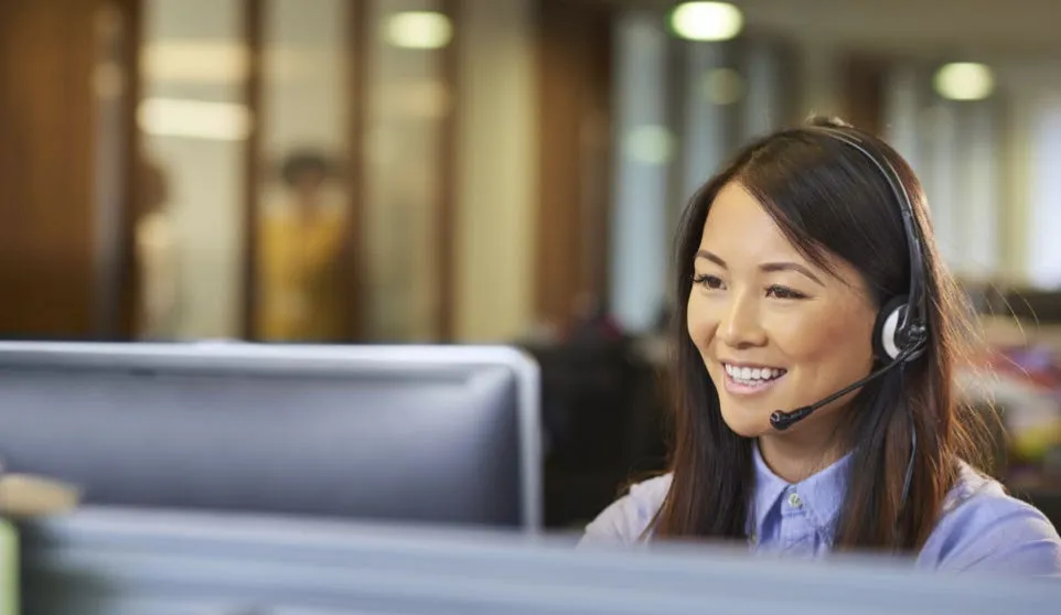 Photo of a customer service representative wearing a headset