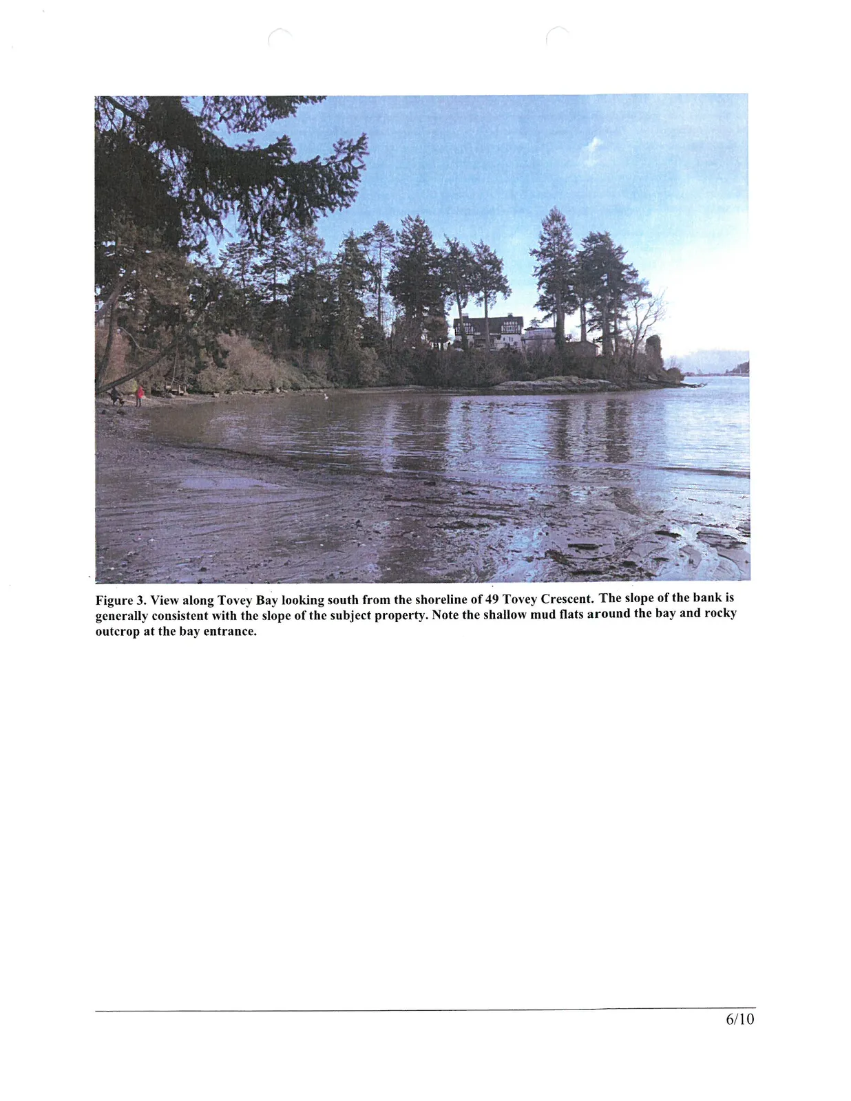 Figure 3. View along Tovey Bay looking south from the shoreline of 49 Tovey Crescent. The slope of the bank is generally consistent with the slope of the subject property. Note the shallow mud flats around the bay and rocky outcrop at the bay entrance.