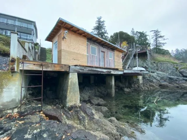Photograph showing a side-profile view of the new boathouse construction on the existing platform structure