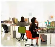 Photograph of people working in a modern, shared common office workspace