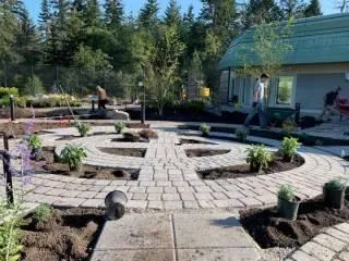 View of the facility from the brick courtyard featuring ornamental grasses