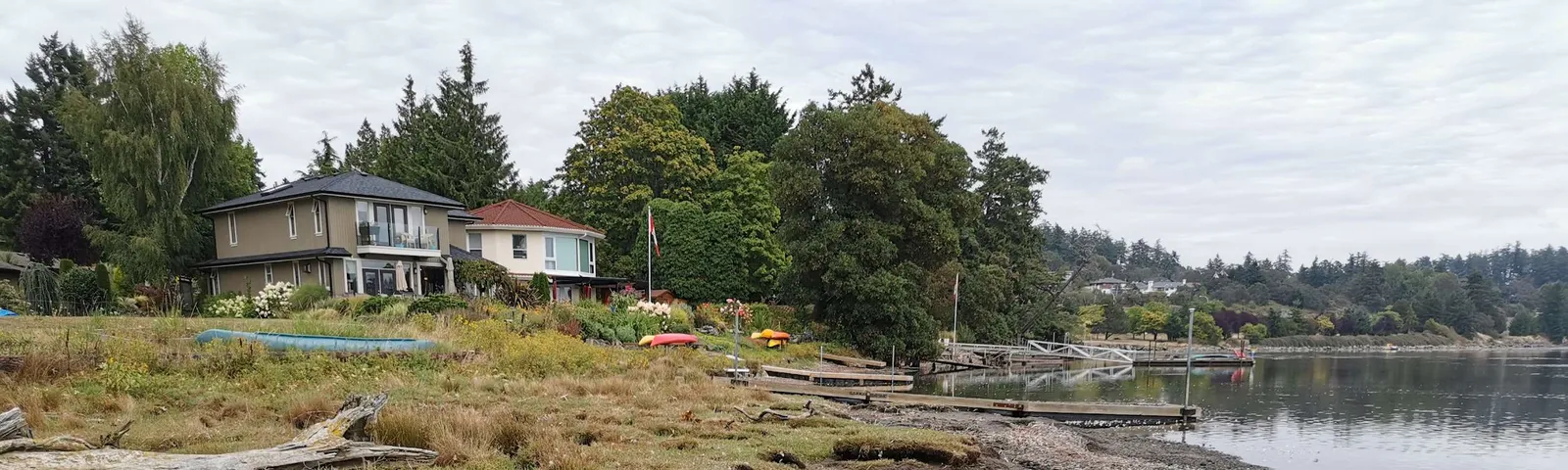 Shoreline photo showing waterfront homes and bank erosion at the Hospital Creek estuary