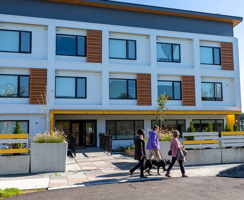 Exterior view of Sarah Ross House with people walking dogs in the foreground
