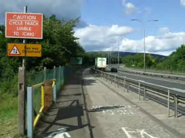 Photograph of a roadway with cycle path signage