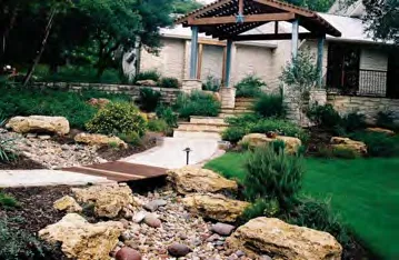 Rendering of the dry creek bed and drainage channel feature with a small bridge and gazebo shelter