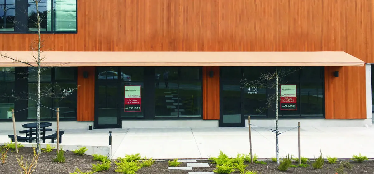 Building frontage photo of units 3-131 and 4-131 Presley Pl showing proposed Lakeside Massage Therapy and TENANT signage locations.