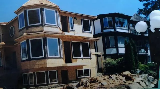 Historical photo of the house under construction showing the patio area and stacked rock