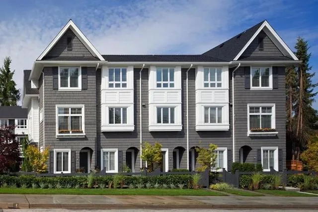 Rendering of traditional-style grey townhouses with white railings and balconies